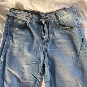 Light wash flare jeans with open hem. Size medium!